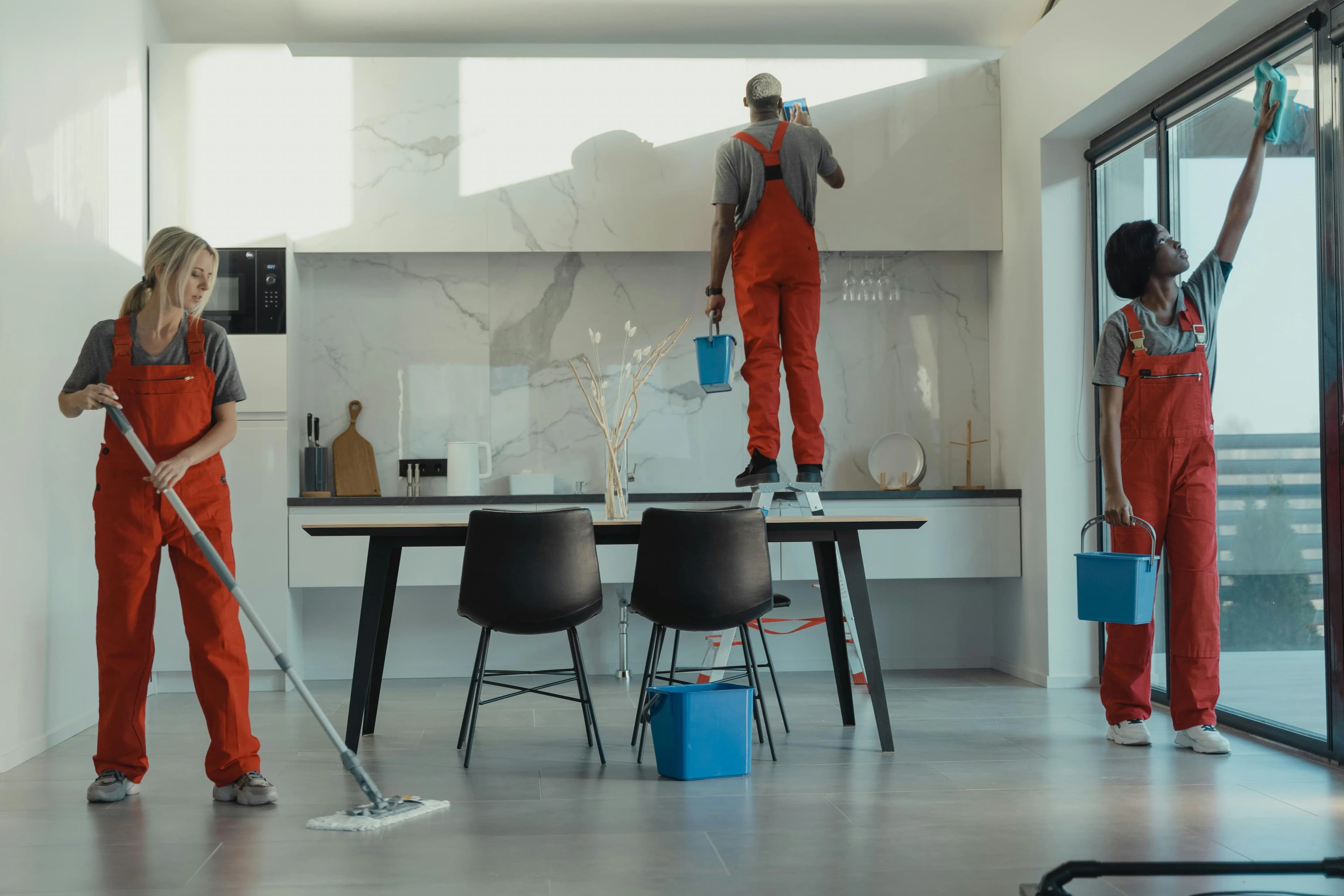 Professional cleaning team with equipment in front of a house